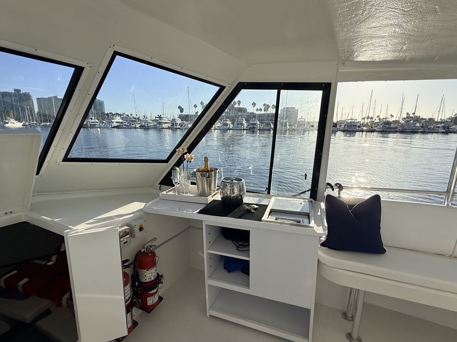 Onboard bottle bar with chilled ice buckets aboard the Aurora Sol harbor cruise boat